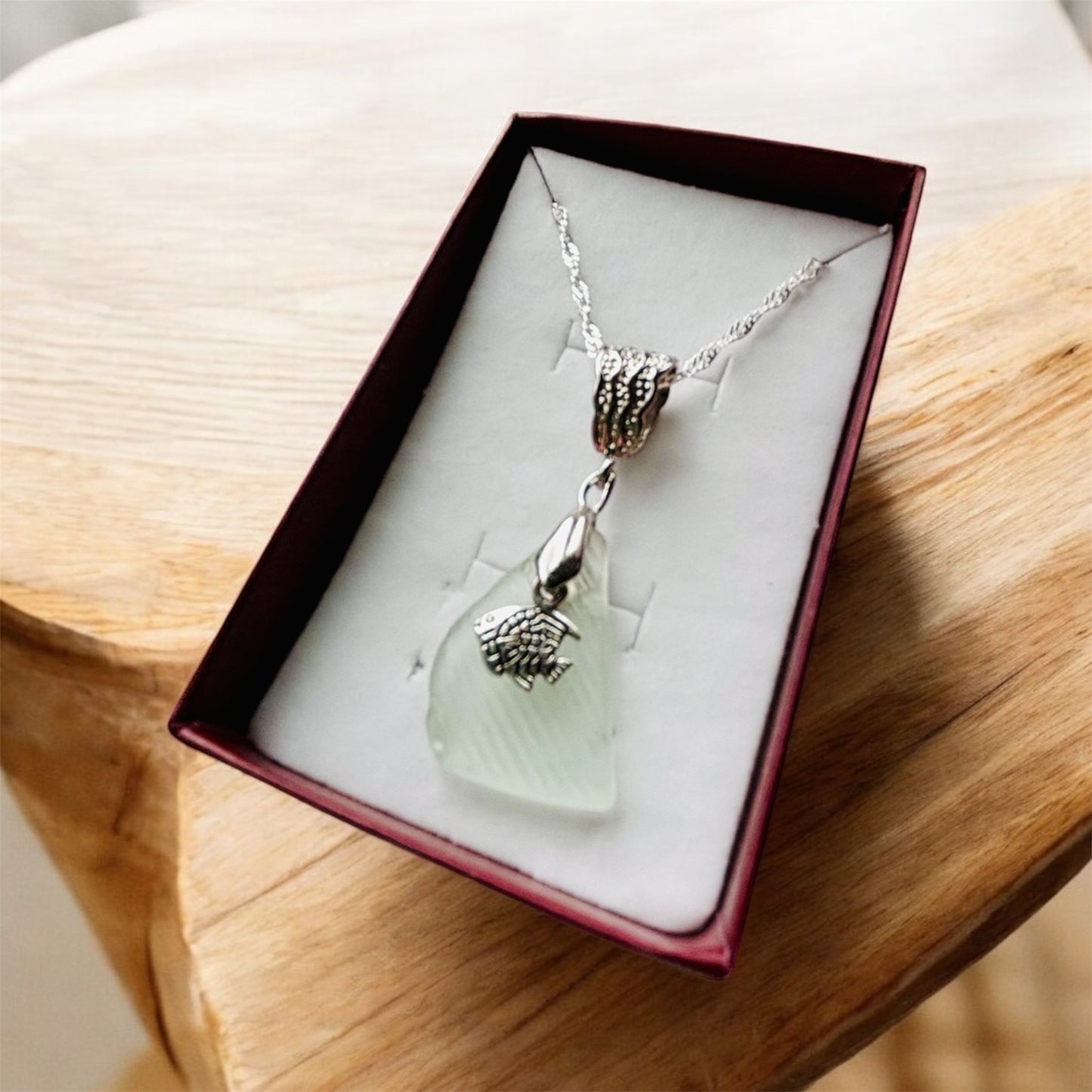 Beautiful handmade White sea glass pendant necklace with fish charm, presented on a 20 inch 925 sterling silver chain