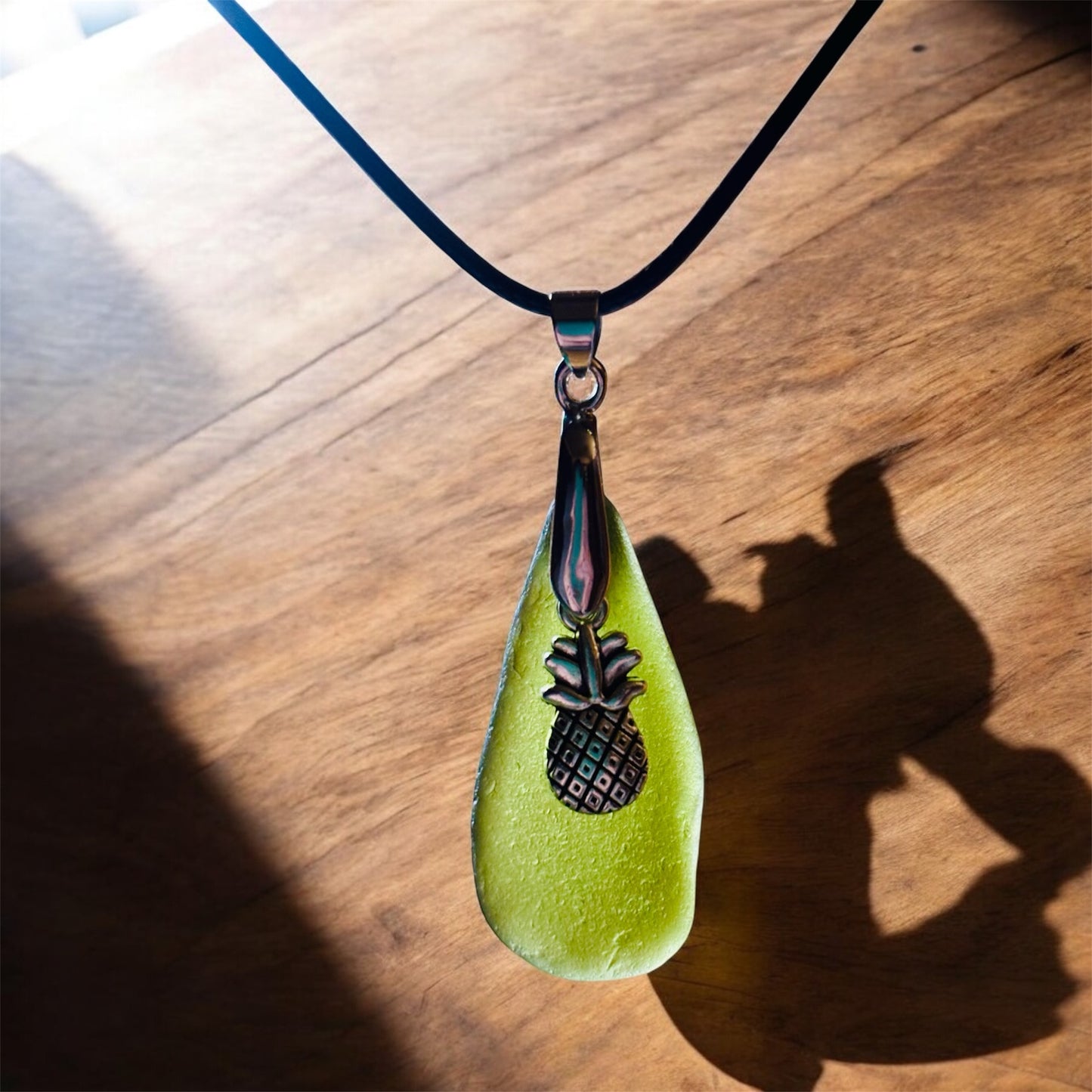 Beautiful Green Seaham sea glass pendant necklace with pineapple charm presented on an 18 inch black nylon chain with a silver lobster clasp