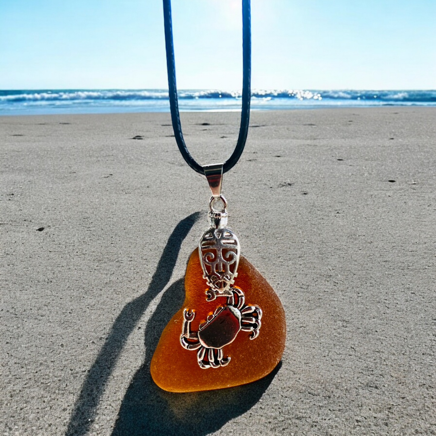 Beautiful handmade Brown sea glass pendant necklace with crab charm presented on a 20 inch black nylon chain with a lobster clasp