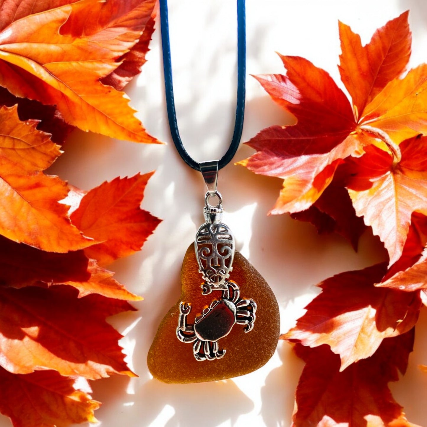 Beautiful handmade Brown sea glass pendant necklace with crab charm presented on a 20 inch black nylon chain with a lobster clasp