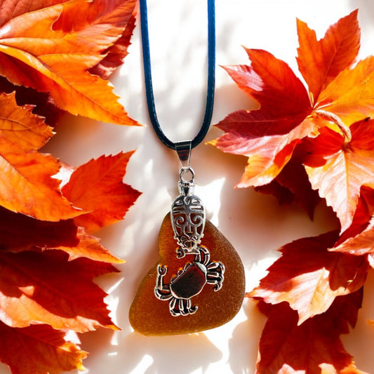 Beautiful handmade Brown sea glass pendant necklace with crab charm presented on a 20 inch black nylon chain with a lobster clasp