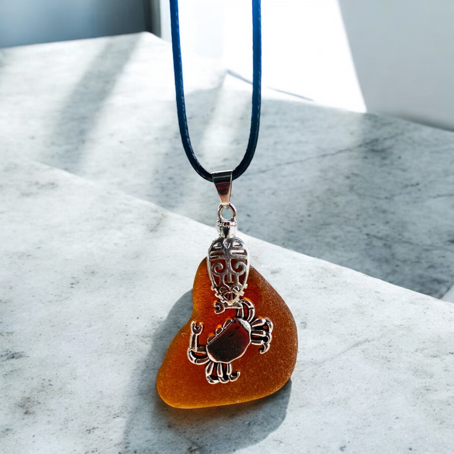 Beautiful handmade Brown sea glass pendant necklace with crab charm presented on a 20 inch black nylon chain with a lobster clasp